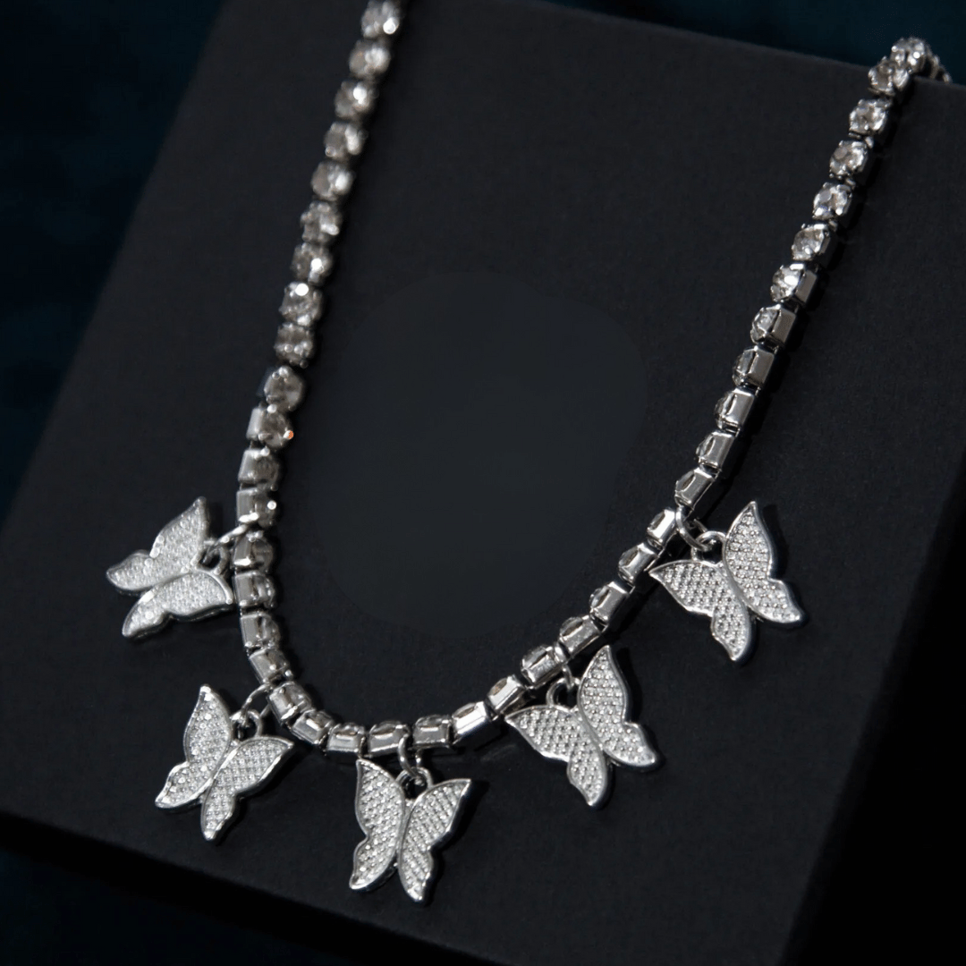 Silver butterfly necklace on a black background