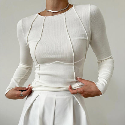 White long-sleeve top and skirt set on a plain background