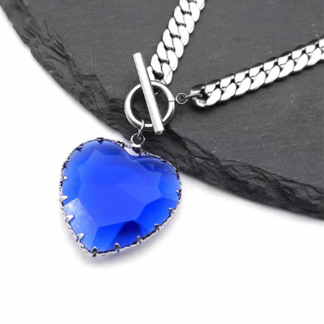 Necklace with a blue heart-shaped pendant on a black slate background