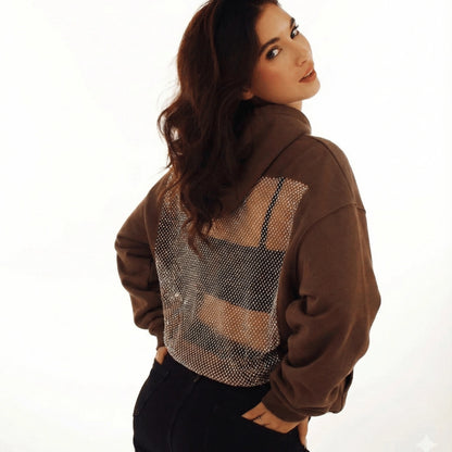 Woman wearing a brown jacket with mesh back panel on a white background