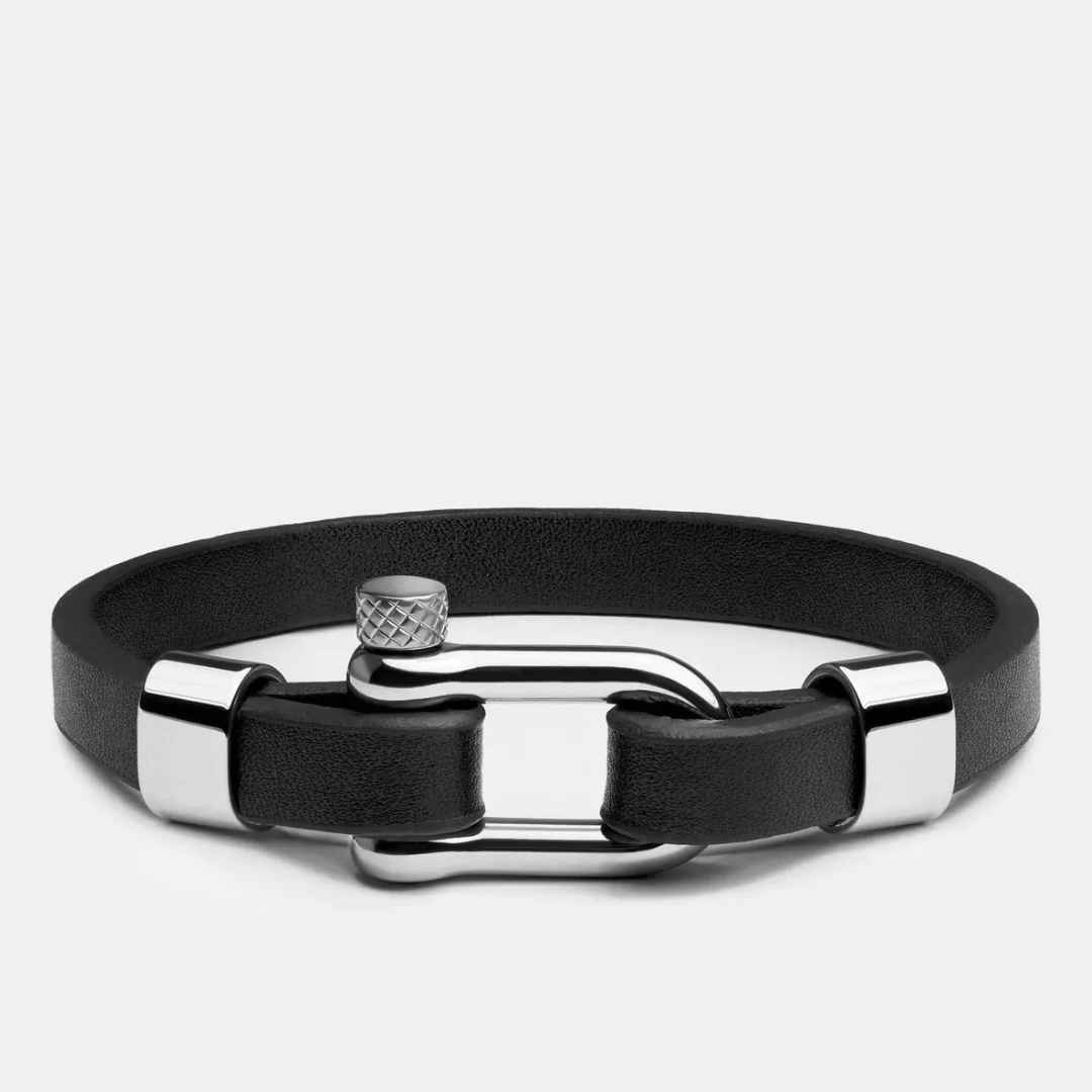 Black leather bracelet with silver clasp on a light gray background