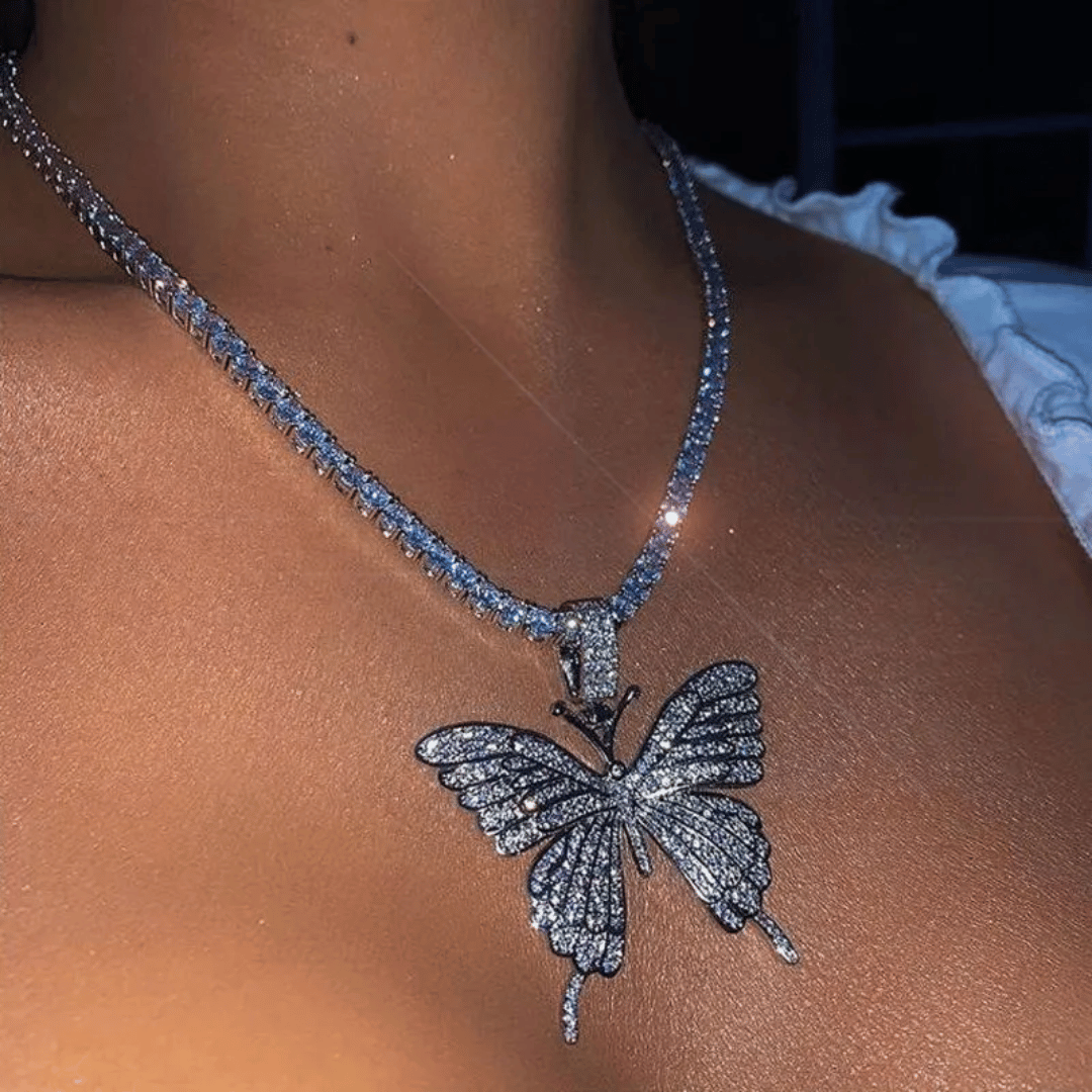 Butterfly necklace with blue stones on a person's neck