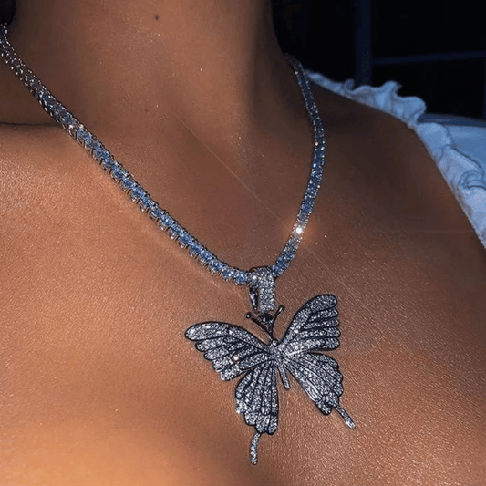 Butterfly necklace with blue stones on a person's neck