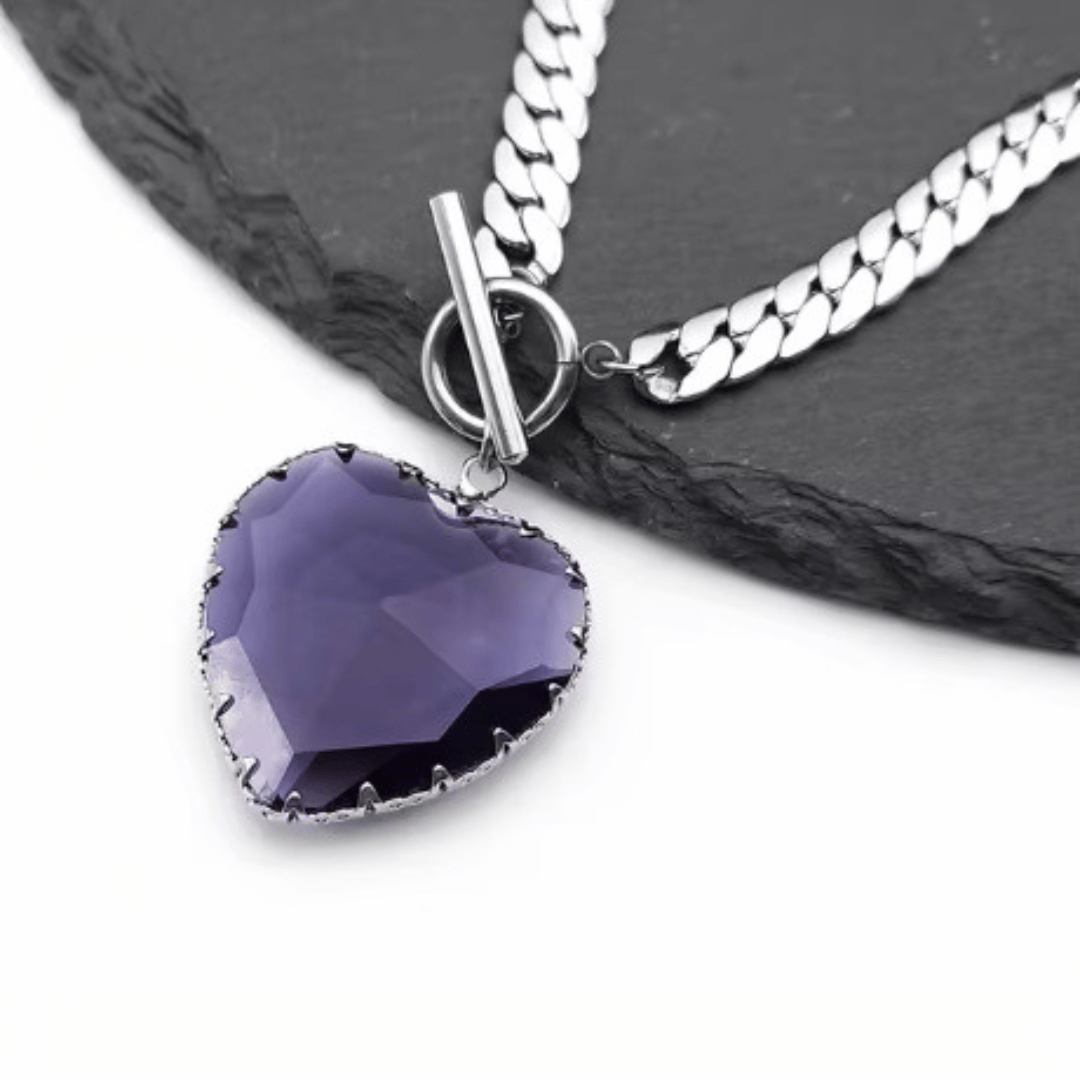 Necklace with a purple heart-shaped pendant on a dark surface