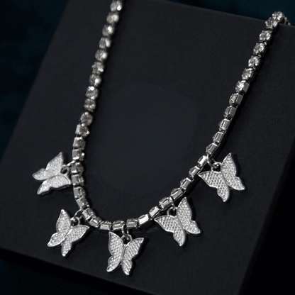 Silver butterfly necklace on a black background
