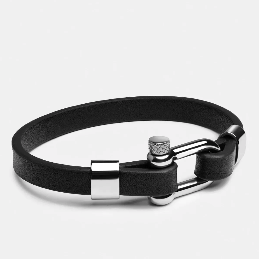 Black leather bracelet with silver clasp on a light gray background