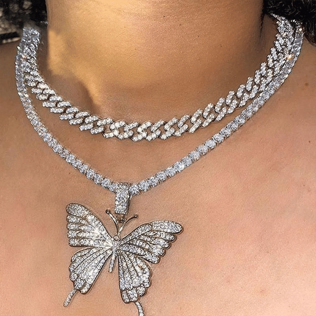 Silver butterfly pendant necklace on a person's neck