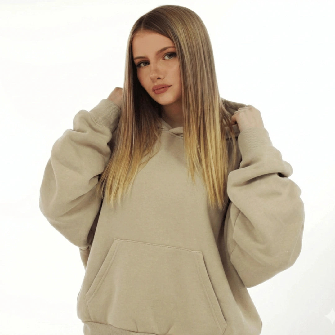 Woman wearing a beige hoodie on a white background