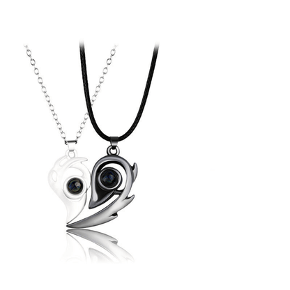 Yin and yang pendant with black and white design on a white background