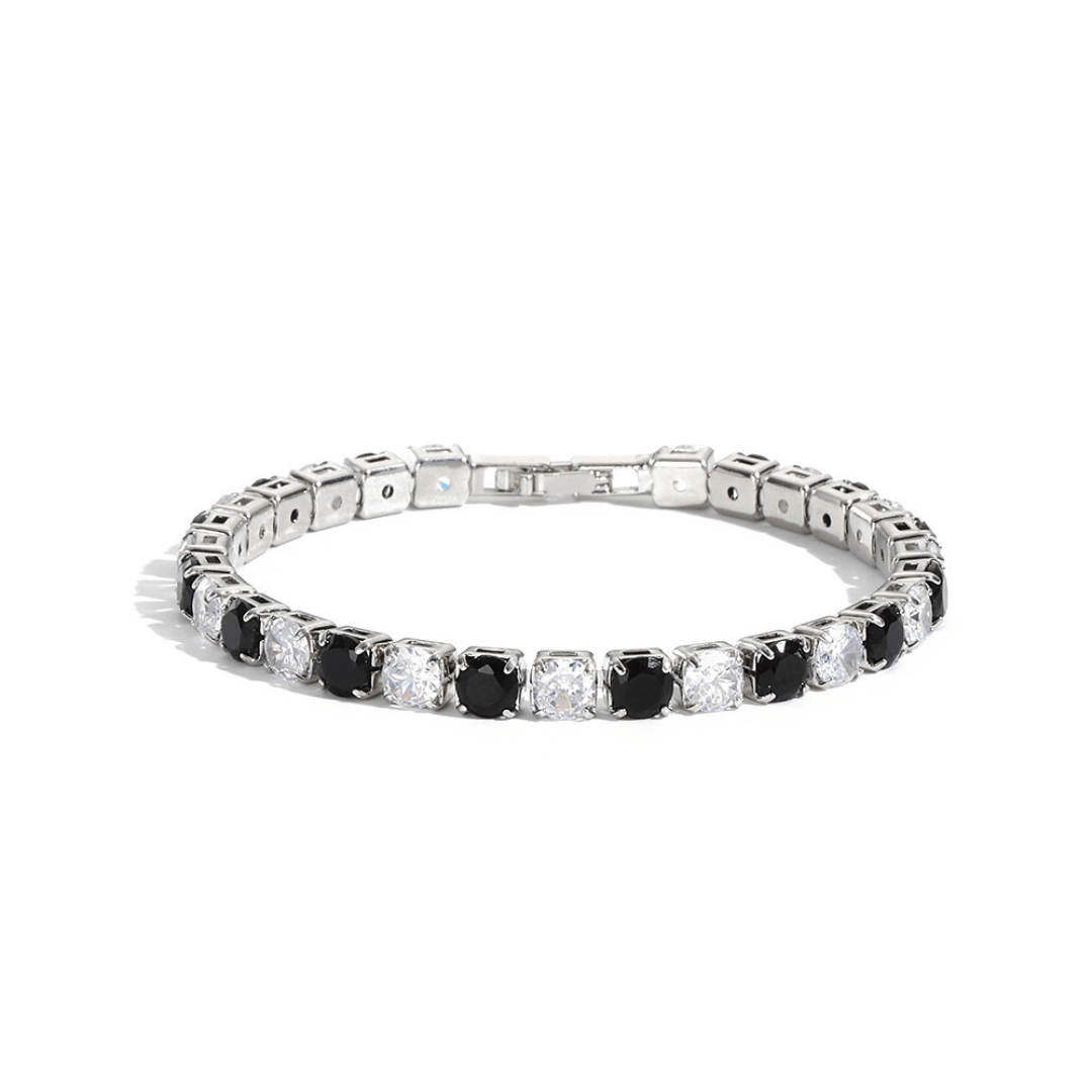 Diamond bracelet with alternating black and clear gemstones on a white background