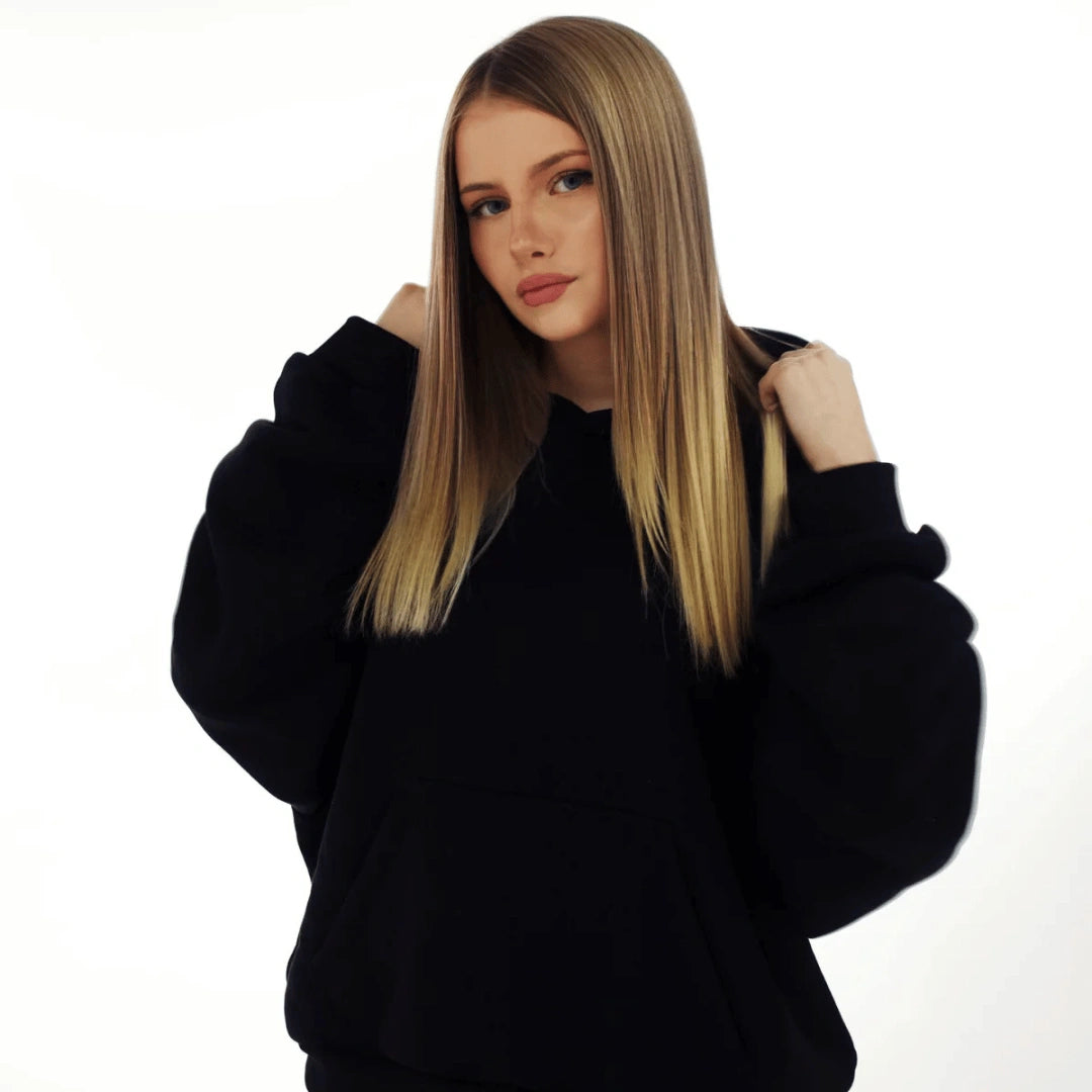 Woman wearing a black hoodie on a white background