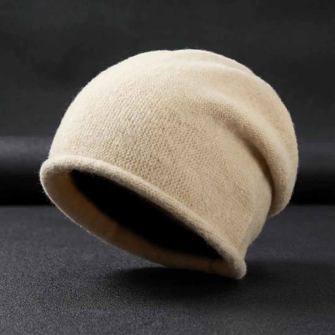 Beige fleece beanie on a black background