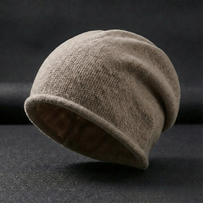 Beige knit beanie on a dark background