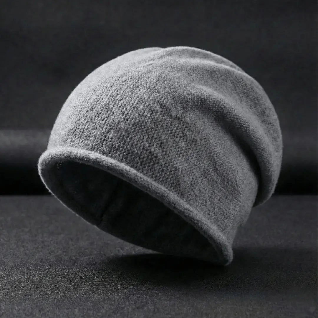 Gray knit beanie on a dark background