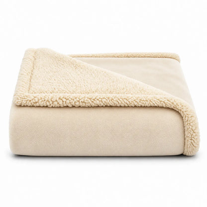 A folded cream-colored fleece blanket with a sherpa lining, shown on a clean white background.
