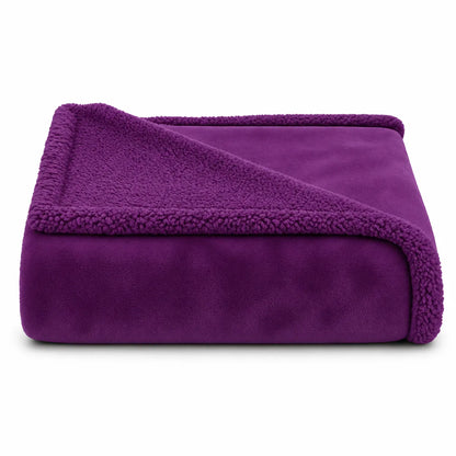 A folded purple fleece blanket with a plush sherpa lining, shown on a clean white background.